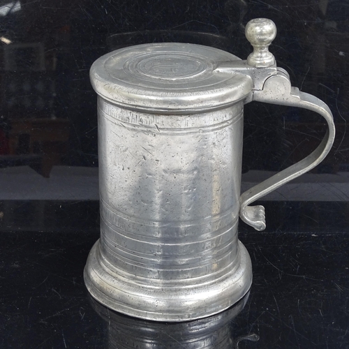 825 - A 19thc pewter tankard, with armorial to the lid.