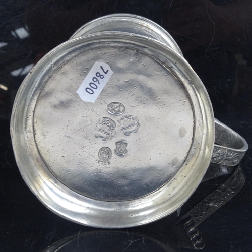 825 - A 19thc pewter tankard, with armorial to the lid.