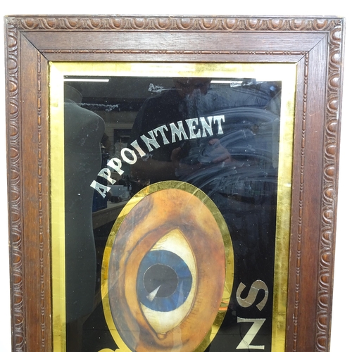 1 - A large Optician's advertising sign, in carved mahogany framed, overall 54cm x 135cm