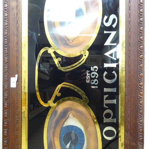 1 - A large Optician's advertising sign, in carved mahogany framed, overall 54cm x 135cm