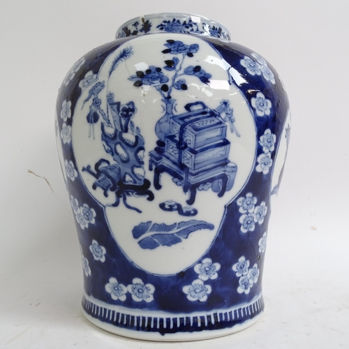 216 - A large Chinese blue and white ginger jar and cover, with genre panels on prunus decorated ground, h... 