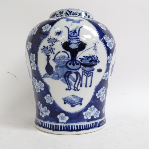 216 - A large Chinese blue and white ginger jar and cover, with genre panels on prunus decorated ground, h... 