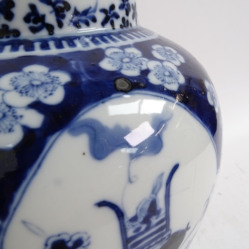 216 - A large Chinese blue and white ginger jar and cover, with genre panels on prunus decorated ground, h... 