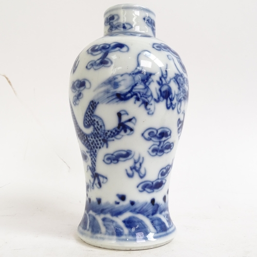 227 - A pair of Chinese blue and white prunus decorated baluster vase and covers, with 4 character mark to... 