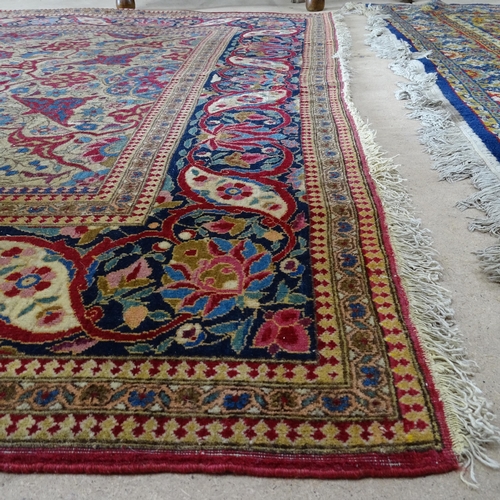 2426 - An Antique red ground Persian Isfahan rug, with repeating border and floral decorated square lozenge... 