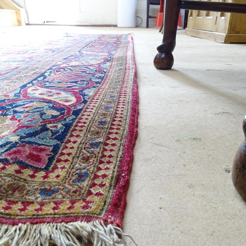 2426 - An Antique red ground Persian Isfahan rug, with repeating border and floral decorated square lozenge... 