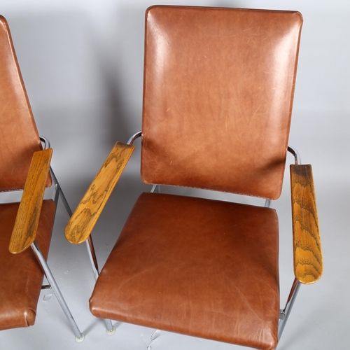 1554 - A pair of 1960s' American Pace chairs by Simmons, with oak armrest on tubular steel, brown leather u... 