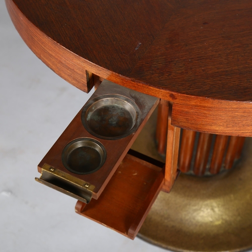 1585 - An Austrian Secessionist games table, circular top with pull out and drop down drinks holders, raise... 