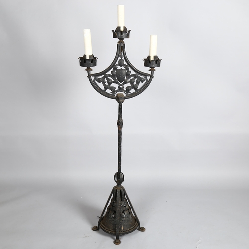 1003 - Boris Karloff, a Gothic style wrought-iron floor standing 3-branch lamp, with pierced metal panels i... 