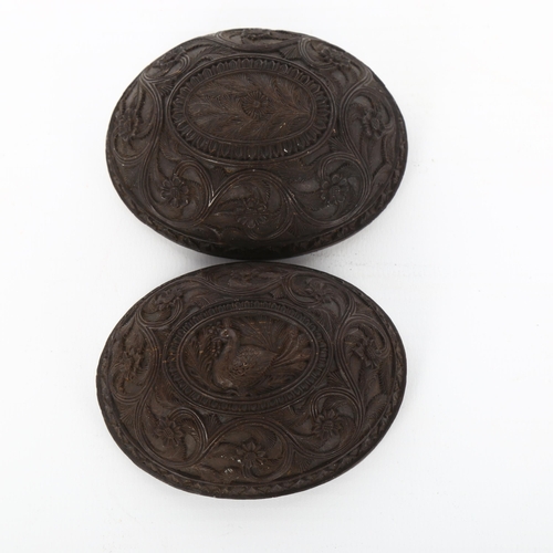 1014 - A pair of 19th century fine relief carved half coconut shells, length 8cm