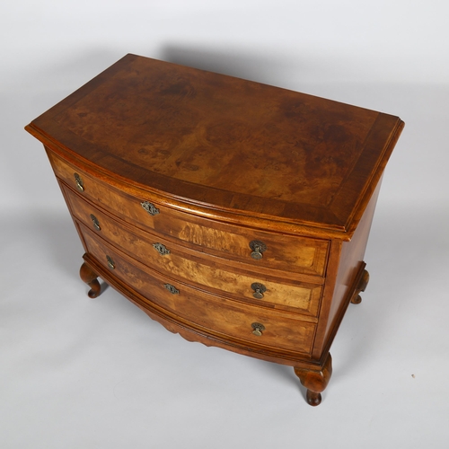 1024 - A burr-walnut bow-front chest of 3 long drawers, early 20th century on cabriole legs, width 90cm, de... 