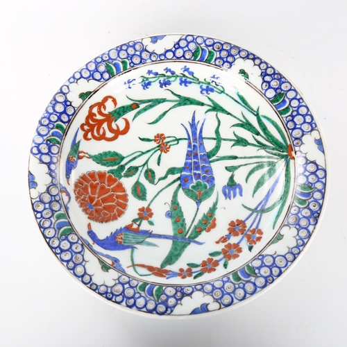 1041 - A Middle Eastern Iznik polychrome glazed plate with exotic bird decoration, diameter 31cm