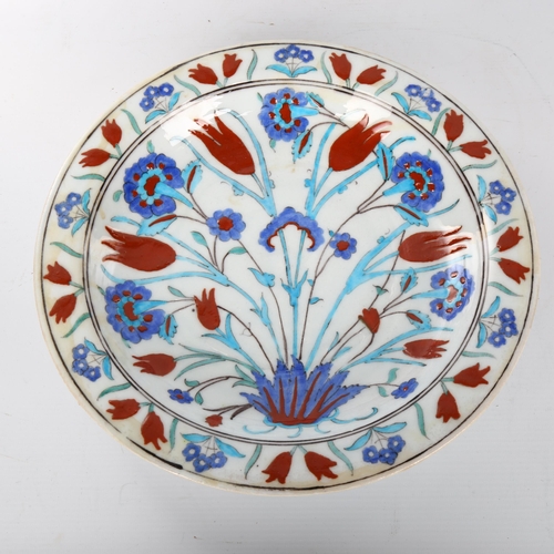 1044 - A Middle Eastern Iznik polychrome glazed pottery plate with floral design, diameter 31cm