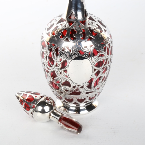 1048 - A 19th century cranberry glass and silver overlay decanter and stopper, height 22cm