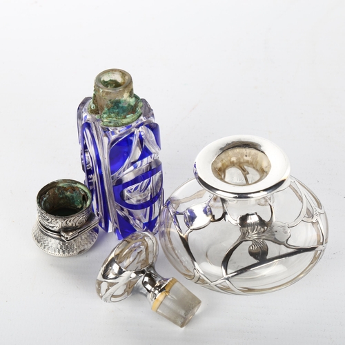 1049 - A Victorian blue overlay perfume bottle with hinged unmarked white metal top, height 9cm, and a clea... 