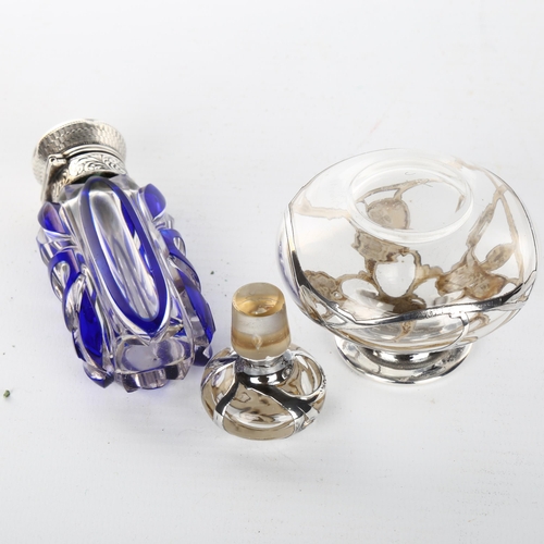 1049 - A Victorian blue overlay perfume bottle with hinged unmarked white metal top, height 9cm, and a clea... 