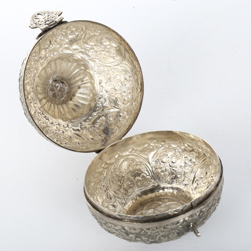 1050 - An unmarked Indian white metal box, with hinged lid and peacock knop, height 13cm, diameter 10cm