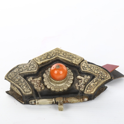 1057 - A Tibetan leather pouch, with unmarked silver mounts and jade bead, width 11cn