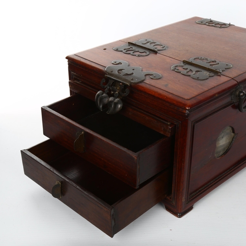 1085 - An Oriental hardwood dressing case, with pierced brass hinges and mounts, and fitted interior with m... 