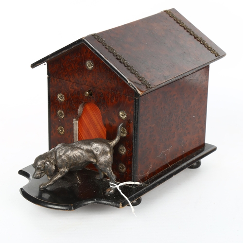 1099 - An early 20th century amboyna dog kennel design cigar box, surmounted by an electroplate dog, length... 