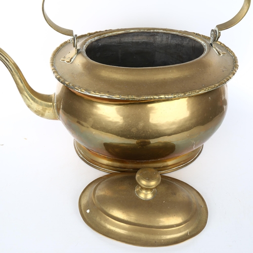 1101 - A very large brass kettle, probably early 20th century, overall length 50cm