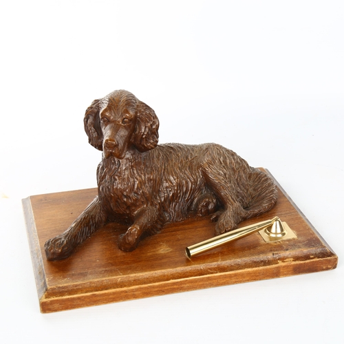 1103 - A carved wood desk stand surmounted by a reclining dog, early 20th century, length 25cm