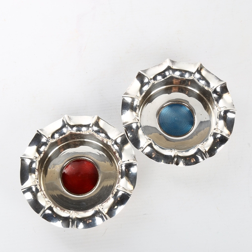 1106 - A pair of electroplate wine coasters, with blue and red enamel centre panels and frilled edges, diam... 