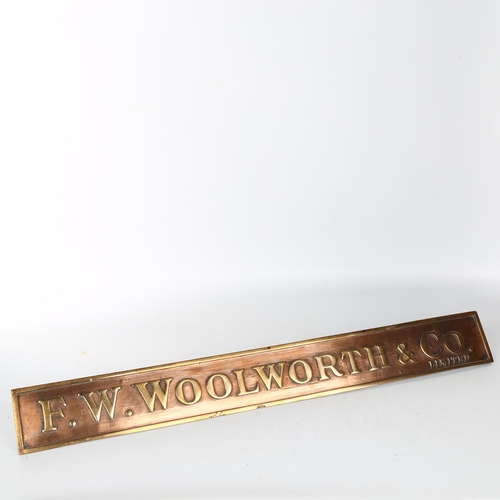 1112 - F. W. Woolworth & Co. Limited relief cast-bronze name plaque on bronze brackets, 63.5cm x 7.5cm