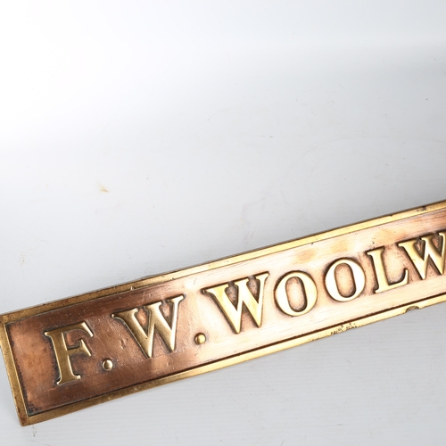 1112 - F. W. Woolworth & Co. Limited relief cast-bronze name plaque on bronze brackets, 63.5cm x 7.5cm