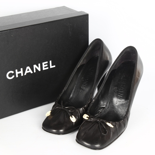 1120 - CHANEL - a pair of lady's black leather high-heeled shoes, size 35.5