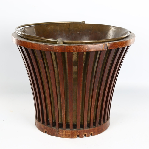 1122 - A Georgian mahogany bucket, with lattice sides, brass liner and brass swing handle, diameter 34cm, h... 