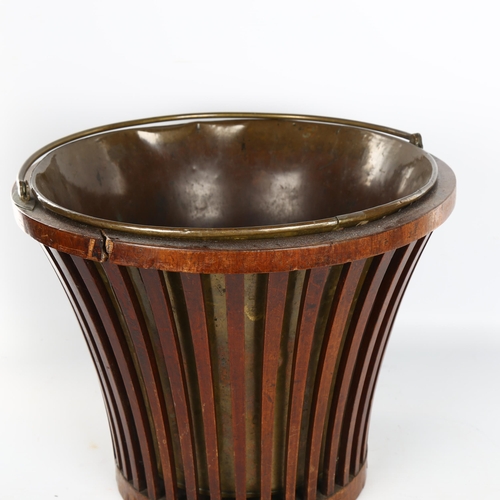 1122 - A Georgian mahogany bucket, with lattice sides, brass liner and brass swing handle, diameter 34cm, h... 