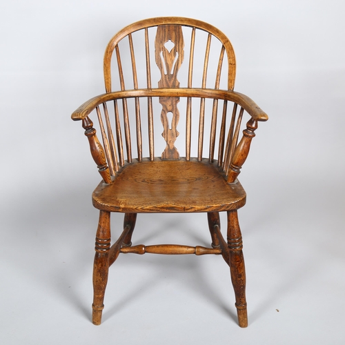 1133 - A late 19th century elm-seated bow-arm Windsor chair