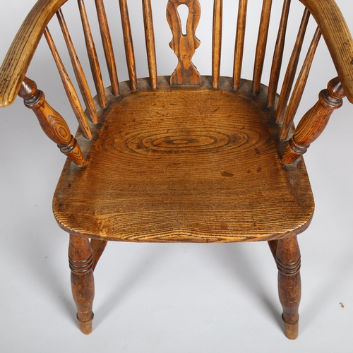 1133 - A late 19th century elm-seated bow-arm Windsor chair