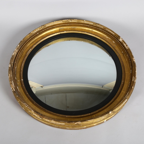 1135 - A large 19th century gilt-gesso framed convex wall mirror, overall diameter 86cm