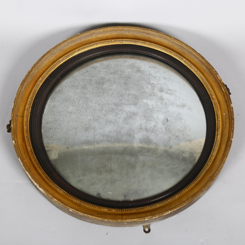 1136 - An early 19th century gilt-framed convex wall mirror, diameter 56cm