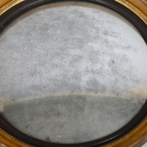 1136 - An early 19th century gilt-framed convex wall mirror, diameter 56cm