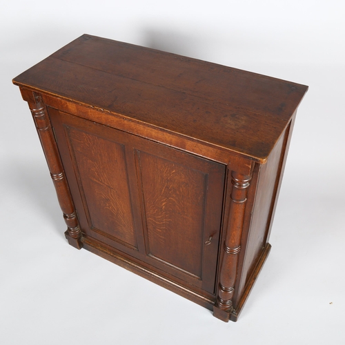 1137 - A Georgian oak side cupboard, with panelled door and split turned column, width 85cm, depth 38cm, he... 