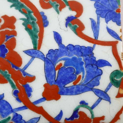 1142 - A Middle Eastern Iznik pottery tile, 25cm x 25cm