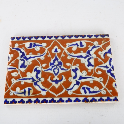 1143 - A Middle Eastern Iznik pottery tile, 16.5cm x 24cm