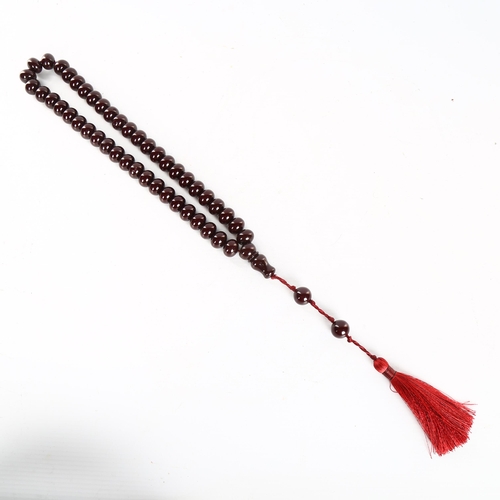 1151 - A string of polished/lacquered wood prayer beads, with tassel, overall length including tassel 51cm