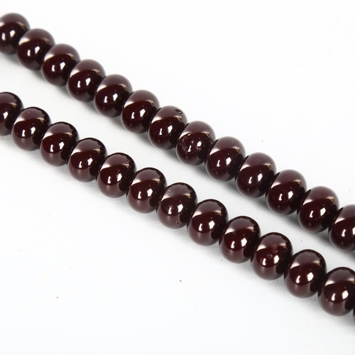 1151 - A string of polished/lacquered wood prayer beads, with tassel, overall length including tassel 51cm