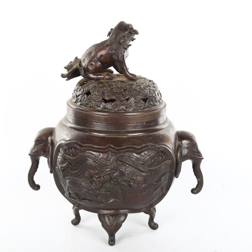 1158 - A Chinese patinated bronze incense burner, with dog of fo finial and elephant handles, height 28cm