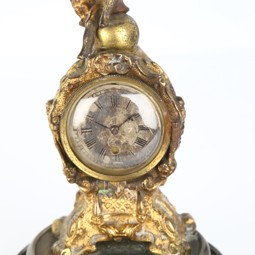 1062 - 19th century French gilt-metal cased miniature clock, surmounted by a figure of Napoleon, movement s... 