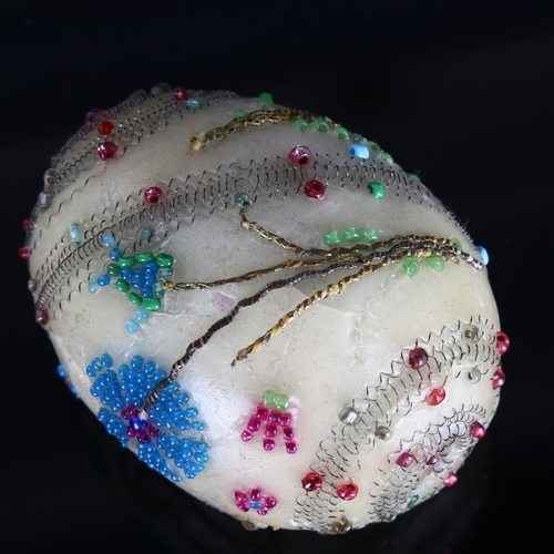 1193 - An Antique wax egg, possibly Russian, with bead and wirework decoration