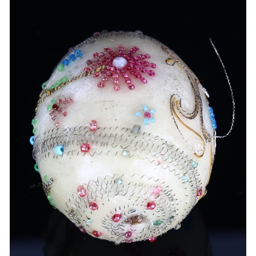 1193 - An Antique wax egg, possibly Russian, with bead and wirework decoration