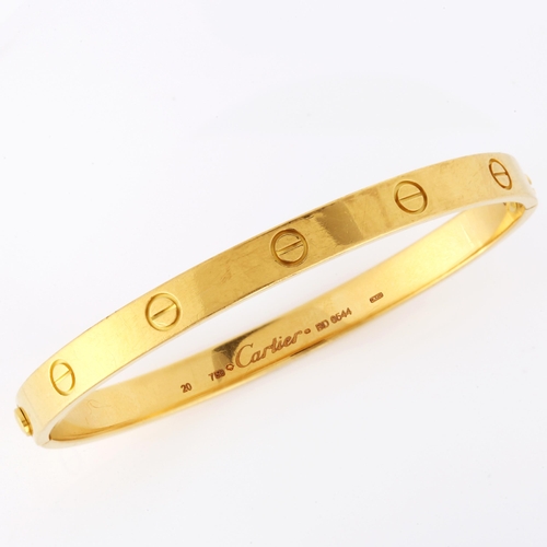 100 - CARTIER - an 18ct gold 'LOVE' bangle, with screw-head motifs, signed Cartier, serial no. BD6544, siz... 
