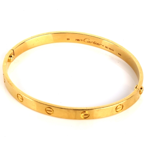 100 - CARTIER - an 18ct gold 'LOVE' bangle, with screw-head motifs, signed Cartier, serial no. BD6544, siz... 