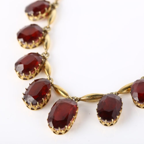 111 - An Edwardian garnet fringe necklace, unmarked yellow metal settings with graduated oval mixed-cut ga... 