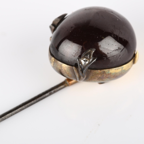 117 - An Antique garnet and diamond hat pin, unmarked yellow metal settings with pear cabochon garnet and ... 